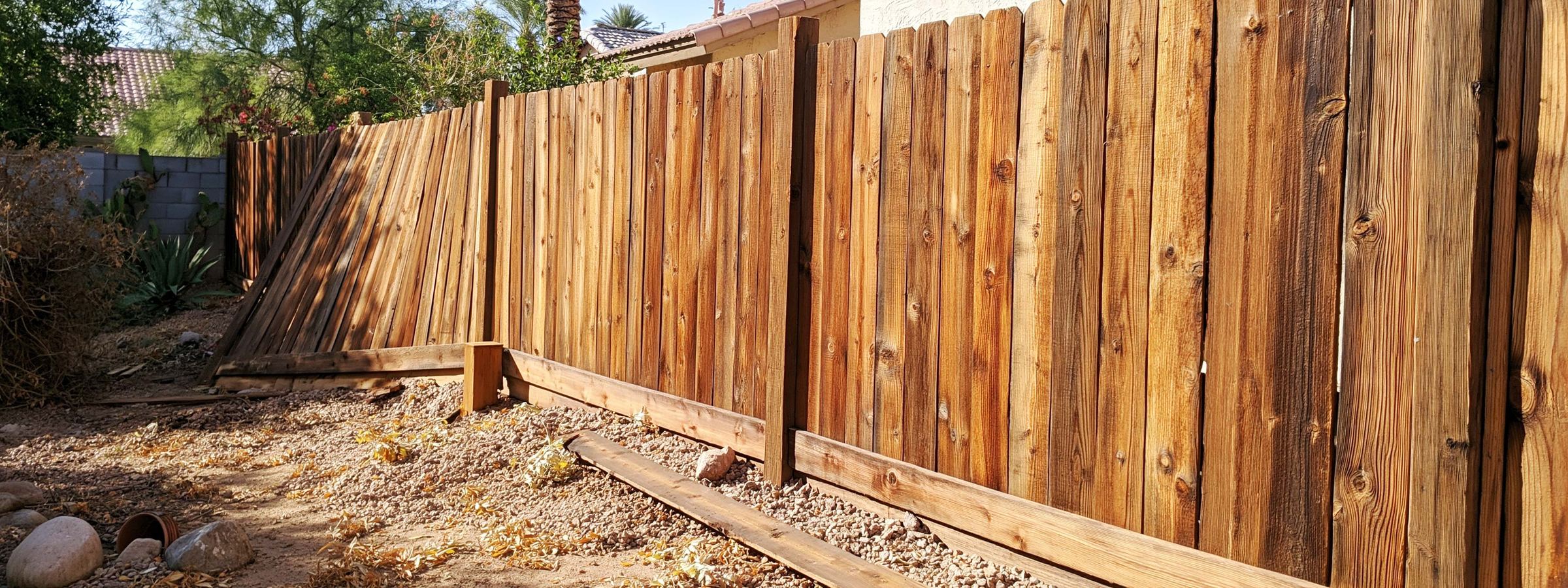 A wood fence on a Queen Creek property with one part standing out of line